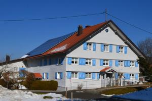 duży biały dom z czerwonym dachem w obiekcie Steibinger Bergnest w mieście Oberstaufen