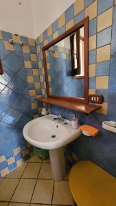 a bathroom with a sink and a mirror at Mamalù Deluxe in Lampedusa