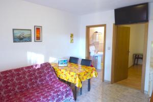 a living room with a table and a couch at Apartments by the sea Ivan Dolac, Hvar - 8782 in Ivan Dolac