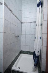 a bathroom with a tub and a shower with a shower curtain at Apartments with a parking space Sveta Nedilja, Hvar - 8792 in Sveta Nedelja