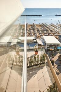 a view of a parking lot with a beach at Hotel delle Nazioni in Pesaro