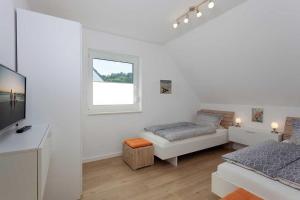 Postel nebo postele na pokoji v ubytování Ferienhaus Alt Sallenthin 10, "Meer"