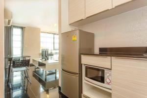 a kitchen with a stainless steel refrigerator and a counter at ibis Styles Chiang Mai in Chiang Mai