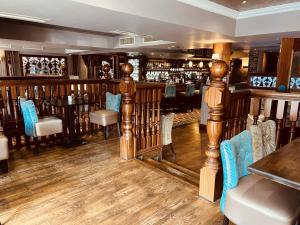 a restaurant with a bar with tables and chairs at The Terrace Hotel in Magherafelt