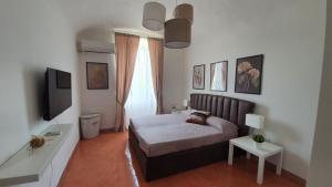 a bedroom with a bed and a television in it at Campani apartment in Rome