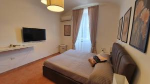 a living room with a couch and a television at Campani apartment in Rome