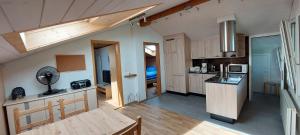 a kitchen with wooden cabinets and a counter top at Chalet Sunnmätteli in Wilderswil