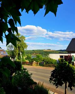 a view of a road with a lake in the distance at Ferienapartment-Barbara in Langscheid