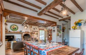 a dining room with a table and a kitchen at Casa Andrea in Culla