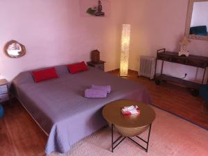 a bedroom with a large bed and a table at La Cueva Refugio in Las Palmas de Gran Canaria