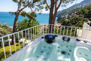 a hot tub on a balcony with a view of the ocean at Decori Suites Amalfi Coast in Vietri