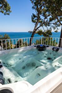 a jacuzzi tub with the ocean in the background at Decori Suites Amalfi Coast in Vietri