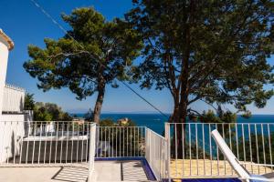 a white gate with a view of the ocean at Decori Suites Amalfi Coast in Vietri sul Mare