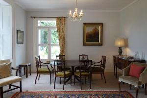 a dining room with a table and chairs at The East Wing in Glasbury