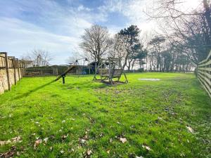 a park with a swing set in the grass at May Isle in Crail