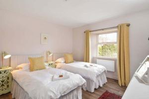 a bedroom with two beds and a window at Kittocks Den in St Andrews