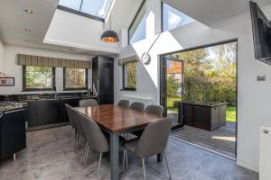 a kitchen and dining room with a wooden table and chairs at The Old Vinery in Crail