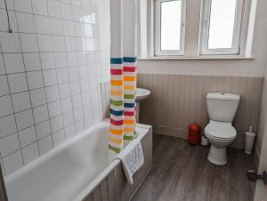 a bathroom with a toilet and a shower curtain at Rosebank in St. Andrews