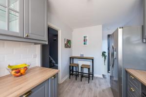 a kitchen with a refrigerator and a table at Beautiful & Modern Seaside Home in Dunbar