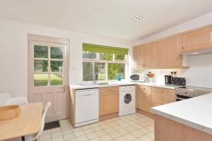 a kitchen with a washer and dryer in it at Kittocks Cottage in St. Andrews