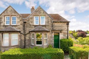 a large brick house with a green door at 30 Lade Braes in St. Andrews