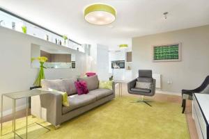 a living room with a couch and a chair at The Golf Flat, Westburn Lane in St. Andrews