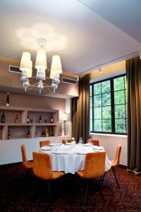 a dining room with a white table and chairs at Best Western Plus Paradise Hotel Dilijan in Dilijan