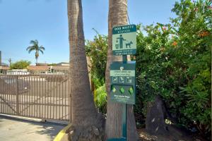 a street sign on a pole next to a palm tree at Studio 6 Suites Lawndale, CA South Bay in Lawndale