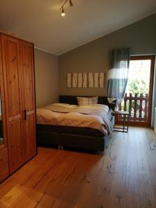 a bedroom with a bed and a large window at Gästehaus Ahlers in Goldenstedt in Goldenstedt