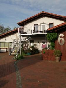 a white house with a staircase on the side of it at Gästehaus Ahlers in Goldenstedt in Goldenstedt