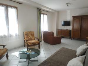 a living room with a couch and a table at Classic House in Argentat