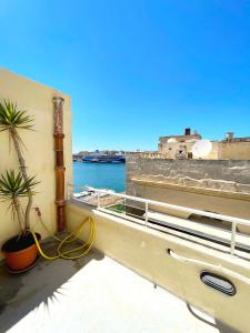 a balcony with a view of the water at MoCo, modern comfort in historic city of Senglea in Senglea