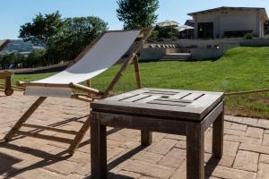 a wooden chair sitting on top of a table at Tenuta San Lodovico in Scansano +66 photos