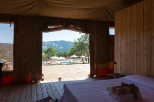 a bedroom with a bed and a large window at Tenuta San Lodovico in Scansano