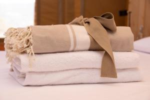a stack of towels with a bow on top of them at Tenuta San Lodovico in Scansano