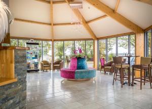 a lobby with a large room with a table and chairs at Croft Country Park in Reynalton