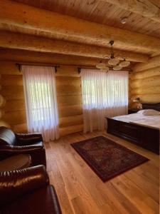 a bedroom with a bed in a log cabin at Cabana Vălul Miresei Apuseni in Răchiţele