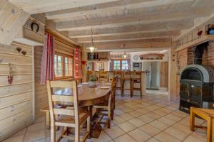 a kitchen and dining room with a table and chairs at La Forge in Manigod