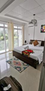 a bedroom with a large bed and a rug at Diamond Plaza in Grand Anse