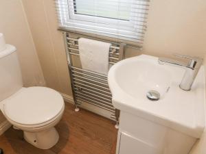 une salle de bain avec des toilettes blanches et un lavabo dans l'établissement Waterside Lodge, à Carnforth 9 autres photos