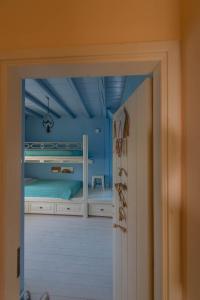 a view of a bedroom with a bed and a doorway at Villa Dimitra - Mani , traditional archontiko in Dhirós