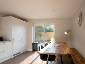 a dining room with a wooden table and chairs at Pass the Keys Stunning 3 Bedroom Home with Free Parking in Bridgwater