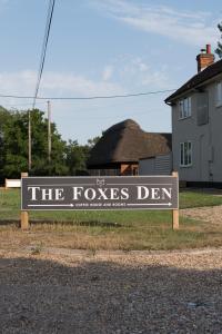 a sign for the foxes den in front of a house at The Foxes Den in Assington
