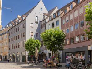 a street in the city with buildings at Limehome Augsburg Annastraße in Augsburg