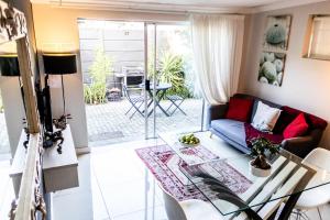 a living room with a couch and a table at Seagull Apartment Hermanus in Hermanus