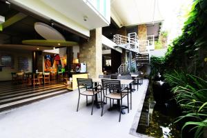 a restaurant with chairs and tables in a building at MaxOneHotels at Bukit Jimbaran in Jimbaran