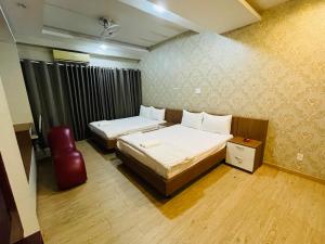 Postel nebo postele na pokoji v ubytování Hotel Quỳnh Anh