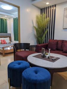 a living room with a couch and a table and chairs at 307 Anabelle Residence at Marina Spatial Condominium in Dumaguete