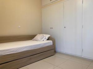 a bedroom with a bed and two wardrobes at Saronic Hearts in Agioi Theodoroi