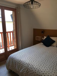 a bedroom with a bed and a large window at Maisonette 'La Toue' in Pyrenees National Park in Arrens-Marsous +27 photos